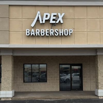 The Apex Barbershop storefront with the white APEX wordmark on a black sign band in Hales Corners.
